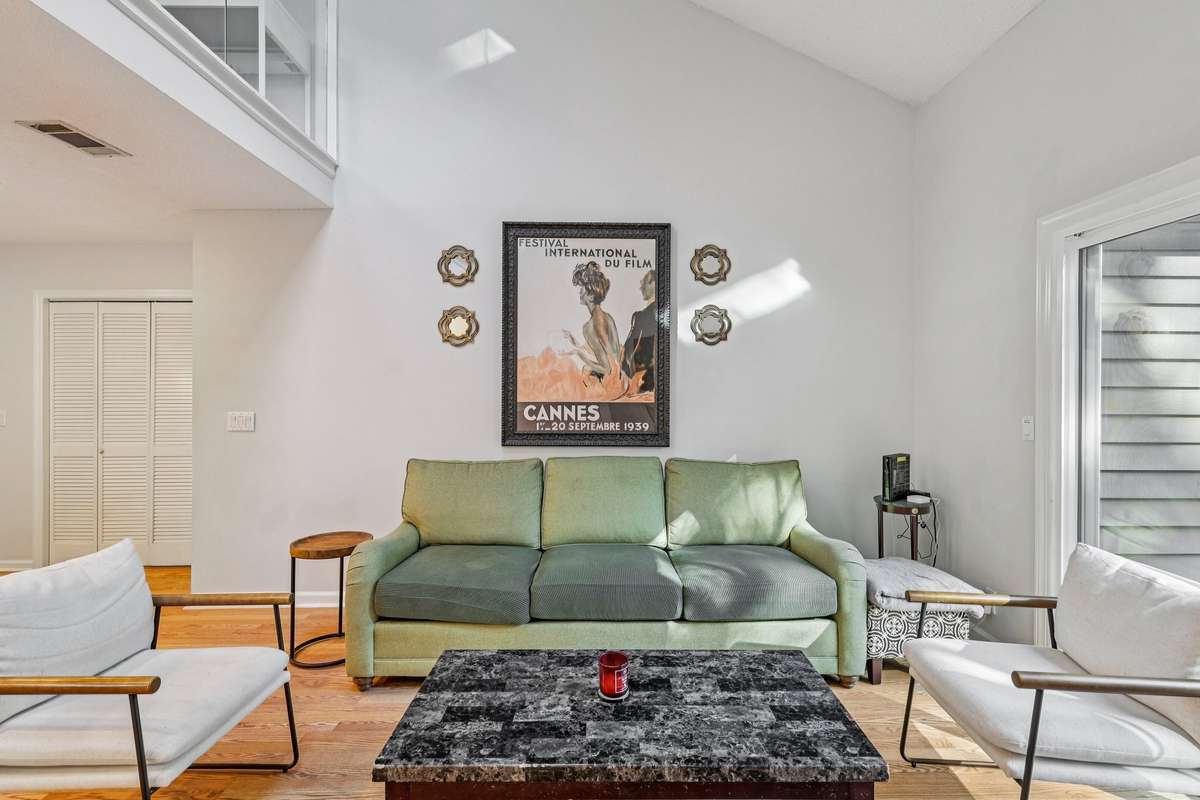 Vaulted ceilings and abundant natural light create a welcoming space perfect for entertaining or relaxing.