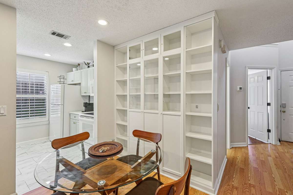 Beautiful built-in shelving provides ample storage and display space, perfectly complementing the open dining area and creating a clean, modern feel just off the kitchen.