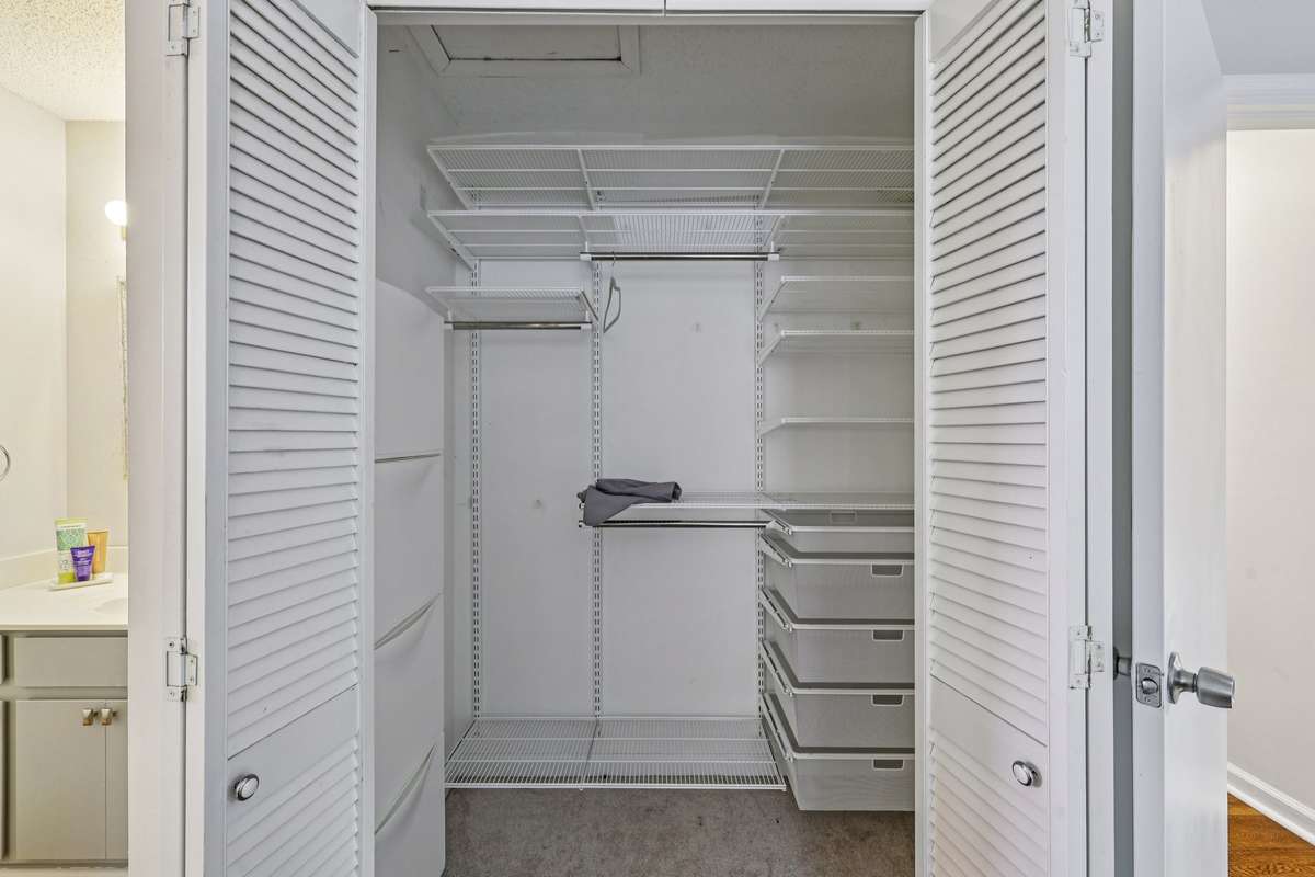 Efficient and functional, this custom closet system includes shelving, drawers, and hanging space to keep everything organized.