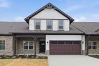 File photo NEW middle unit 3/3, 2 car, 2 bedrms down/2 bath, 1 bedrm/bath up, great rm/kitchen, covered back porch, patio/Blinds/stainless pkg/refrigerator/kitchen Tile backsplash/under cabinet lighting/Owners Tile shower/laminate/carpet/tile & more!