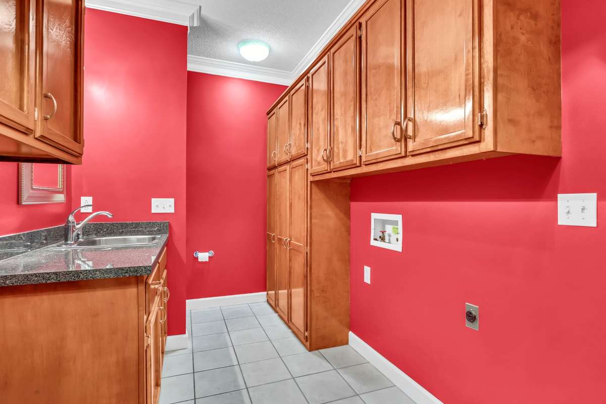 Laundry room & half bath together in large space with tons of cabinets