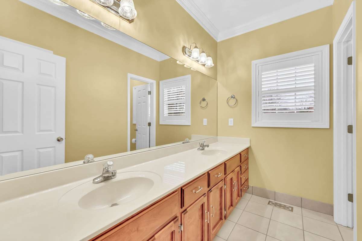 Hall shared bathroom with double sinks