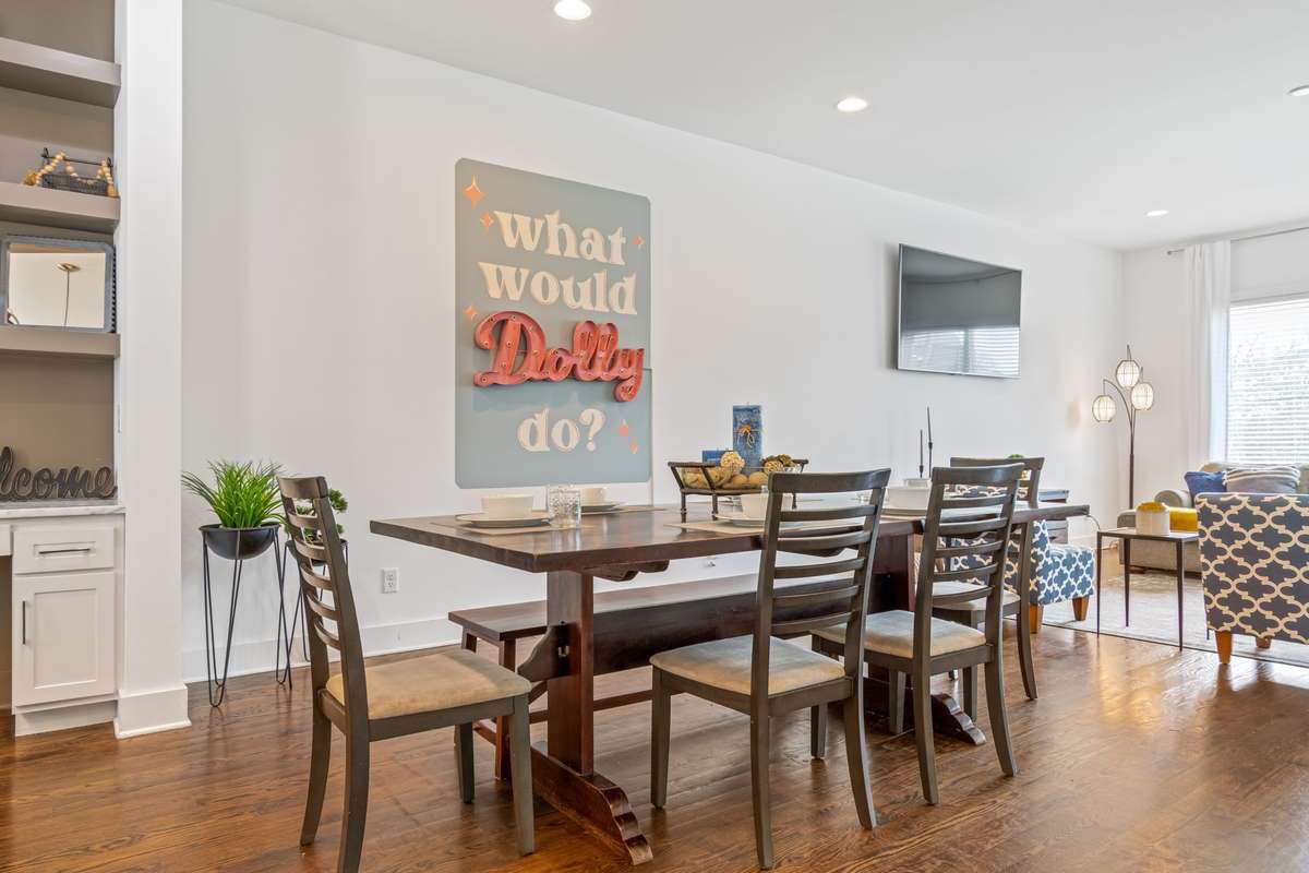 The dining area sits perfectly between the kitchen and living room, creating a welcoming, connected space ideal for hosting and daily life.