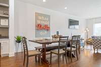 The dining area sits perfectly between the kitchen and living room, creating a welcoming, connected space ideal for hosting and daily life.