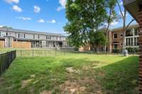 Fenced common area ideal for outdoor activities.