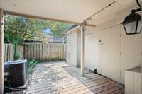 Fenced patio with string lights — great for relaxing!
