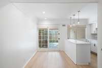 Sleek kitchen with quartz counters and white cabinetry.