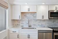 Classic kitchen style with marble and a farm style sink!