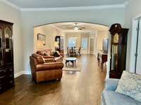 As you enter this lovely home, notice the beautiful finished wood flooring and the arched opening. Look at how spacious this home is!