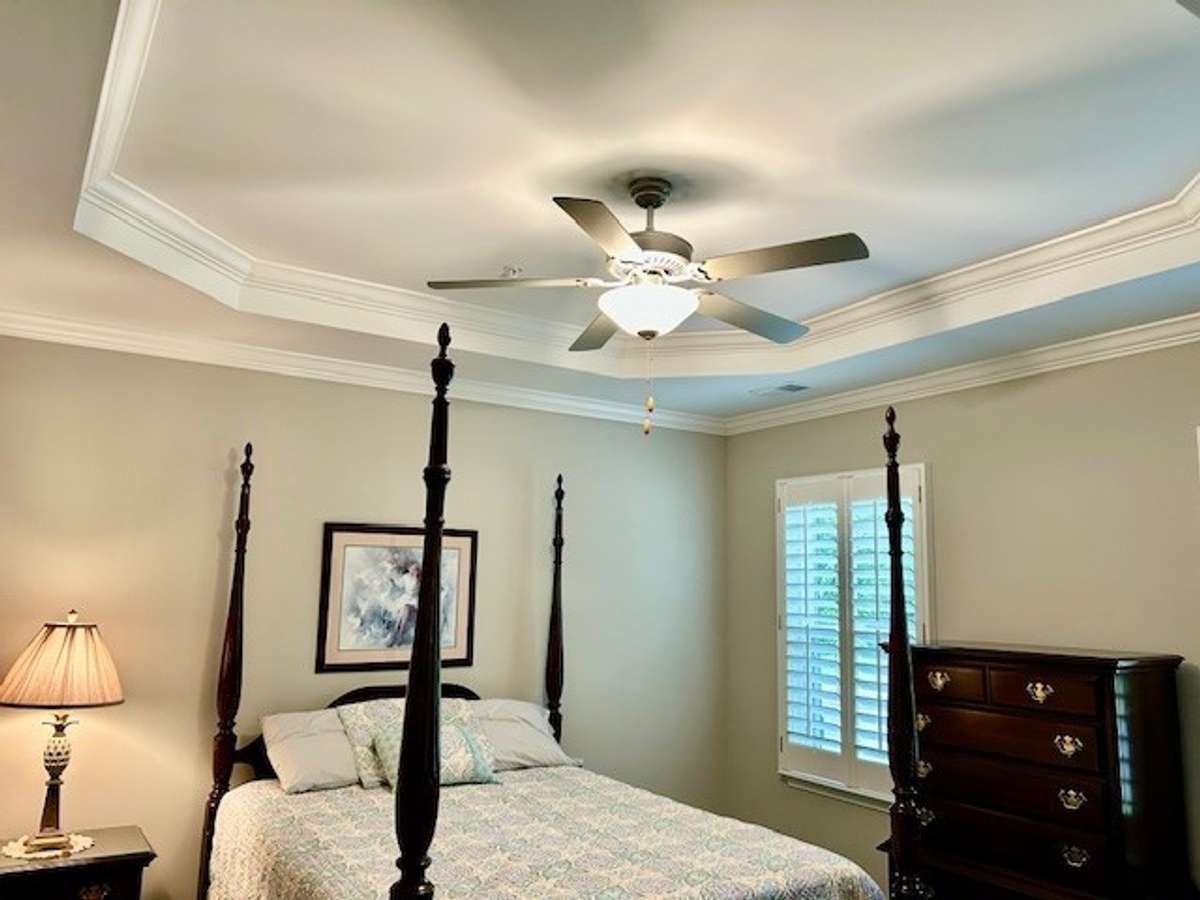 The primary bedroom has a beautiful tray ceiling with fan.