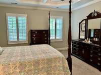 Notice the double windows in the primary bedroom with plantation shutters.