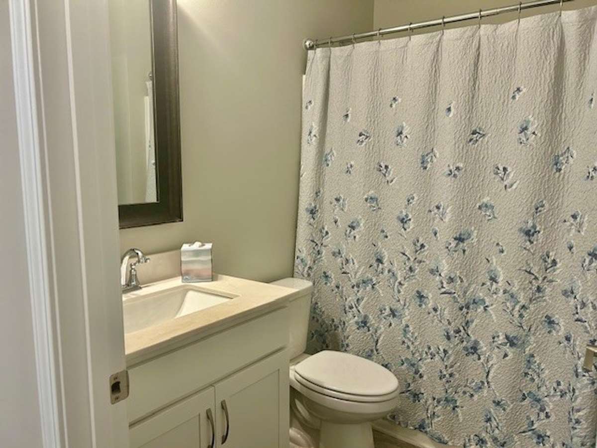 Full bath is located next to the second bedroom. It has a ceramic tile floor.