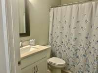 Full bath is located next to the second bedroom. It has a ceramic tile floor.