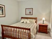 Second bedroom is adorned with carpet and located next to the hall bath.