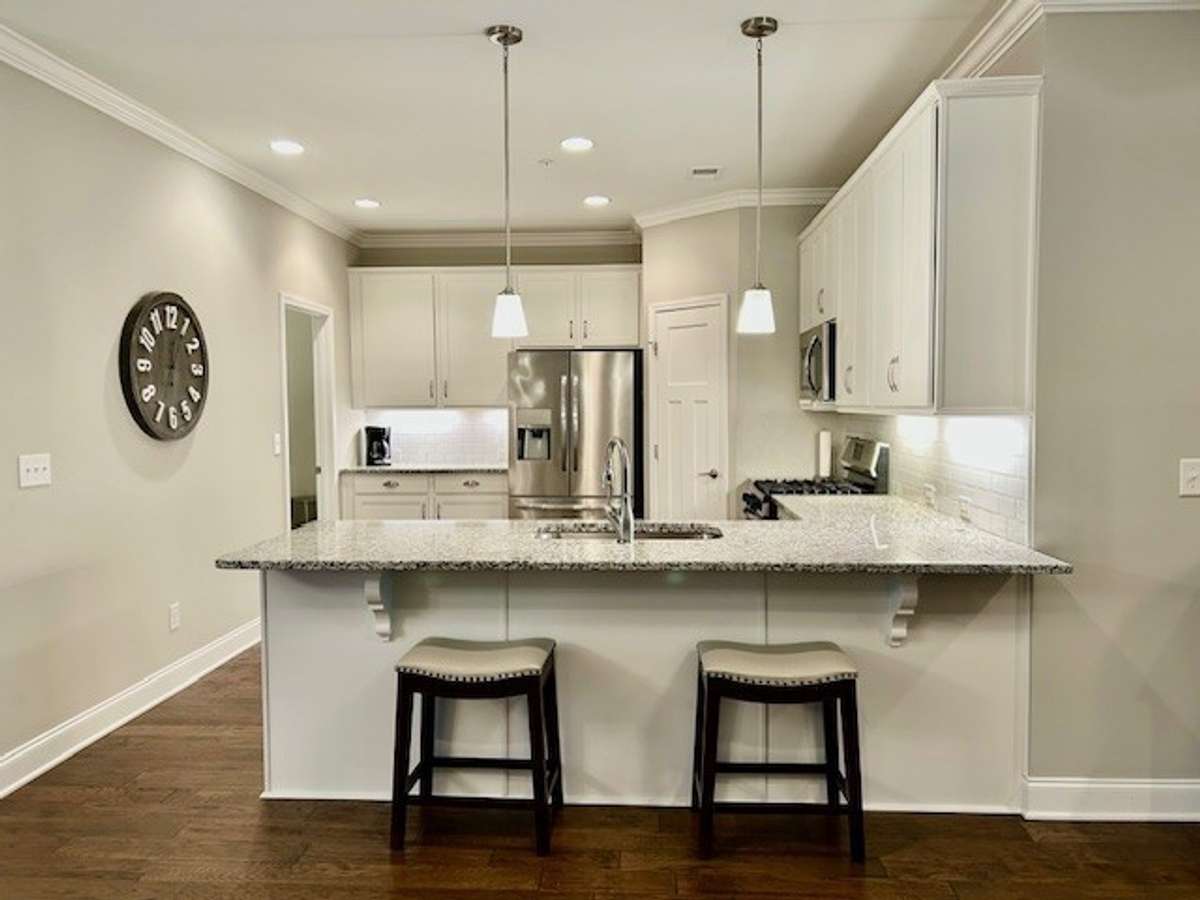 This stainless steel refrigerator in the kitchen conveys with the house.