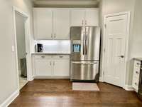 A large walk-in pantry can be found in the corner of the kitchen.