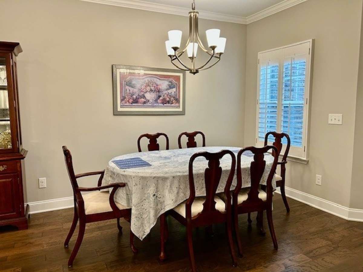 Notice the plantation shutters that are found throughout the home in this lovely dining area.
