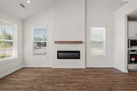 Electric fireplace and floating wood mantle. Outlet already installed above the mantle so it's ready to go for a TV!