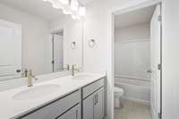 Upstairs bathroom with quartz countertops and double vanity