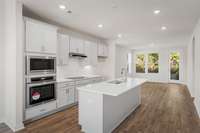 Gorgeous light gray cabinets with enough bar seating for 4 people at the island!