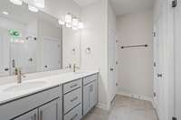 Primary Bathroom with quartz countertops, double vanity, large walk-in shower (tiled to the ceiling), a water closet and a linen closet!