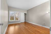 Bedroom 2 w/wood floors + good-sized closet
