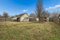 Large backyard - fully fenced with additional covered storage by the detached building.
