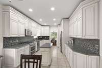 Custom cabinetry, granite, tile, double gas oven and ample room to prepare is a chefs dream!