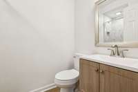 Primary Bathroom with brand new vanity, toilet, flooring and paint.