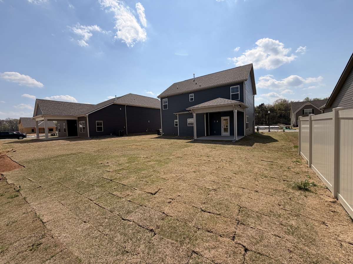 Flat, spacious backyard with a covered back porch for you to enjoy!