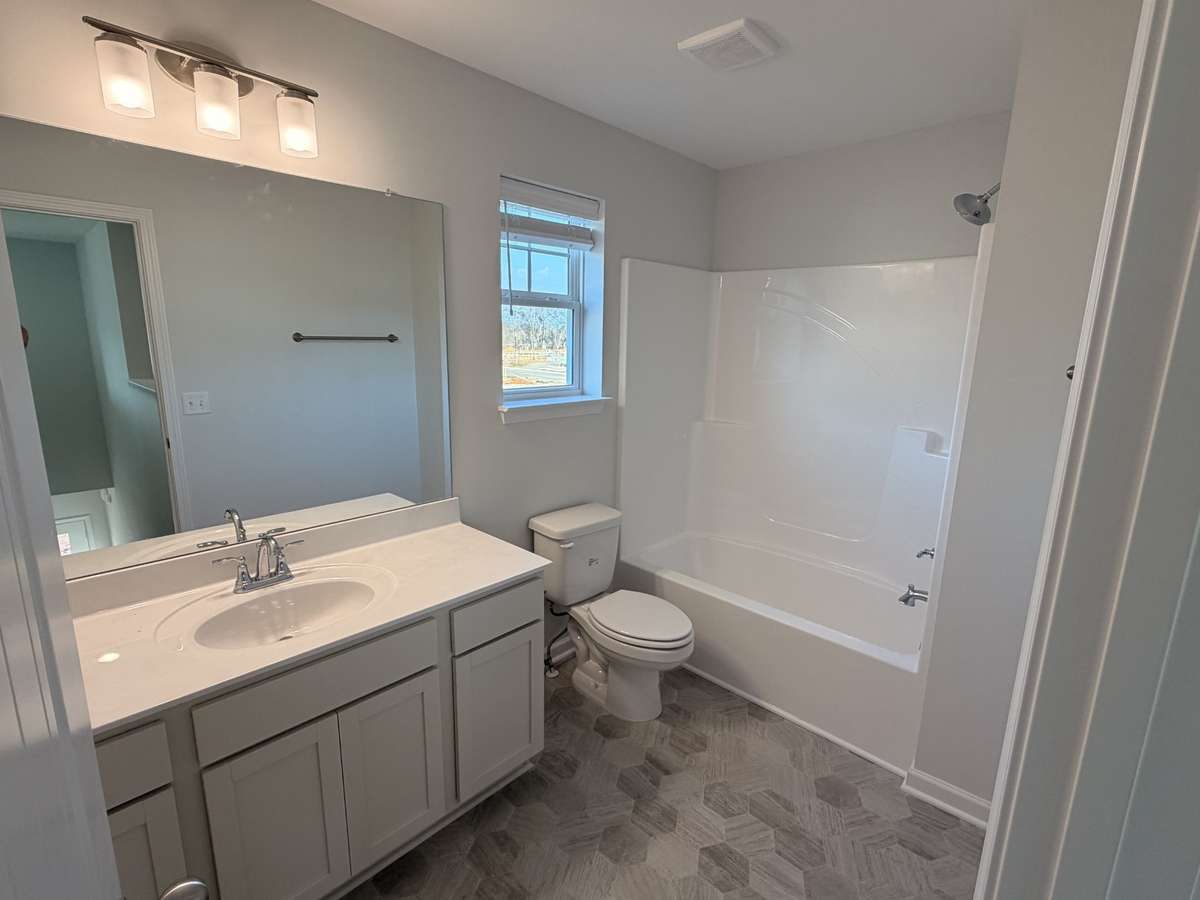 Bathroom 2 - Features the Easy clean vinyl flooring, fiberglass tub/shower combo and plenty of counter space on this vanity!