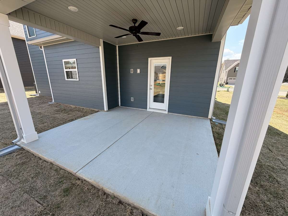 Covered Back Porch with a ceiling fan and outlets for an outdoor TV!