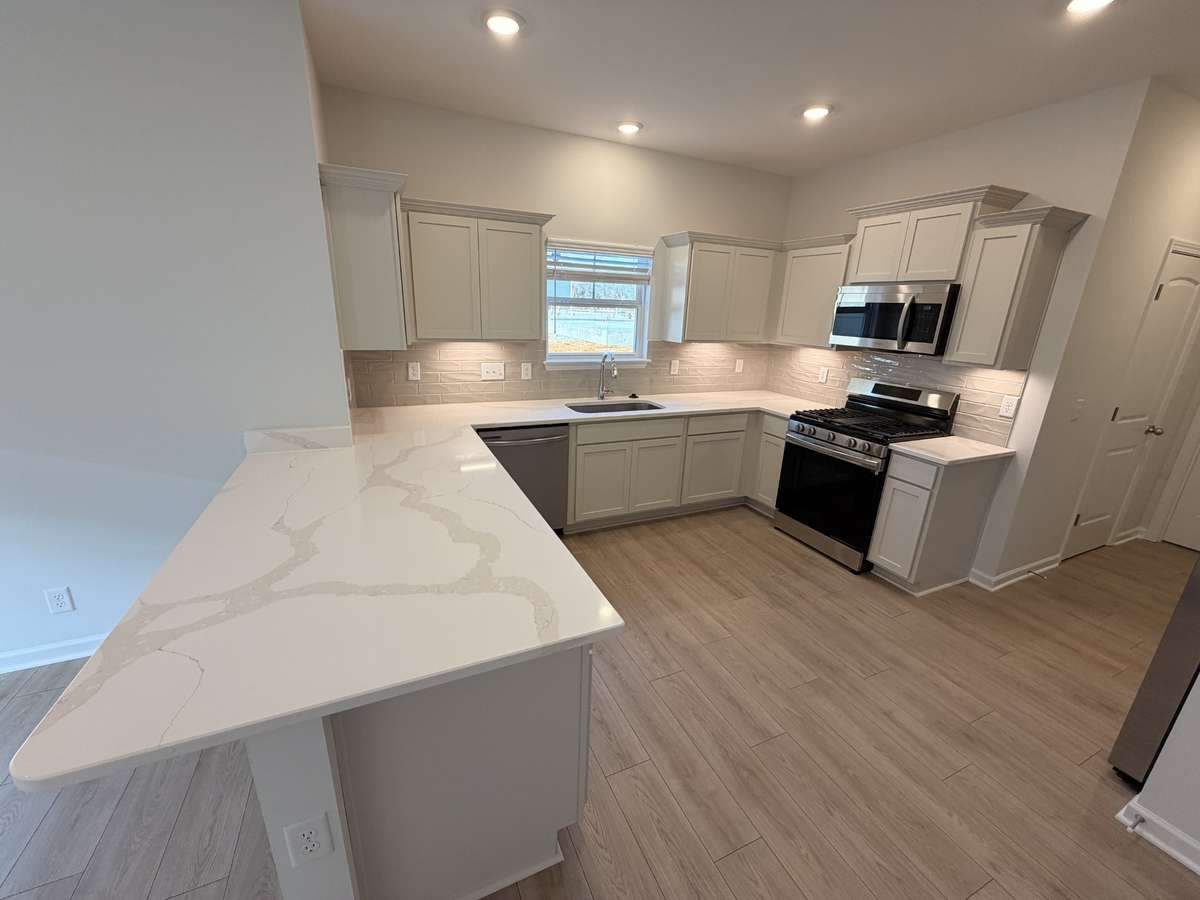 Home features Quartz Kitchen Countertops, Subway Tiled Backsplash and Stainless Steel appliances!