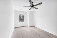 Second bedroom upstairs with ceiling fan