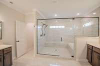Primary Bathroom with a Luxurious Walk-in Tile Shower with 2 Shower Heads and a Soaker Tub, All Enclosed Behind Glass!
