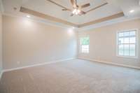 EXAMPLE>>>Large Primary Bedroom Located on the Main Level Features a Double Tray Ceiling, Crown Molding and Recessed Lighting!! Primary Bedroom will Have Wood Flooring!