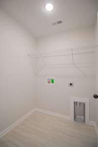 Spacious Laundry Room with Tile Flooring and Shelving!!