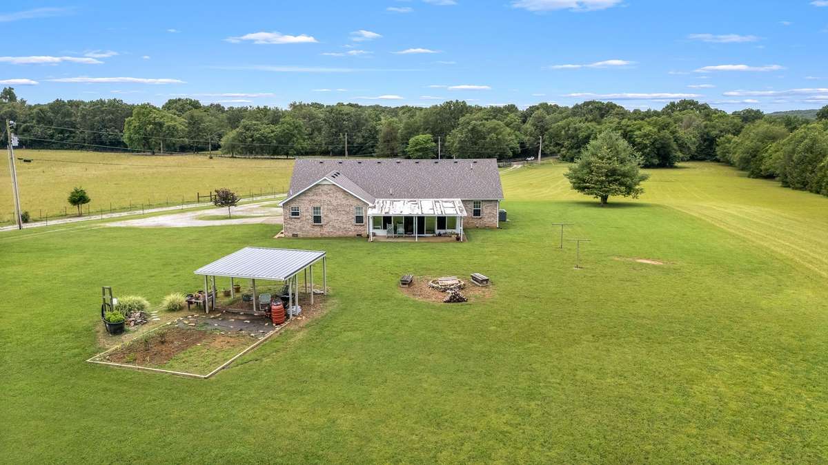 Aerial view of home, pergola and fire pit.