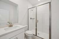 A full bathroom is located on the main level and includes a tiled walk-in shower.