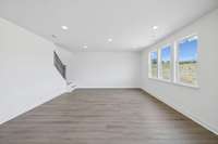 The great room features an open concept design with abundant natural light, creating an inviting atmosphere ideal for entertaining and relaxing.