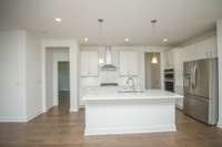 Photos displayed are of a model home. Actual options, finishes, colors, and selections may differ in the home being offered for sale.