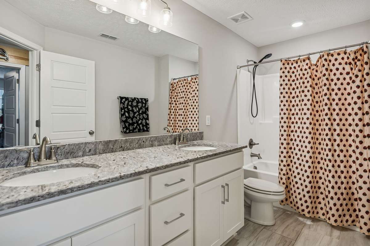 The second full bathroom ALSO has double sinks and a tub/shower combination.