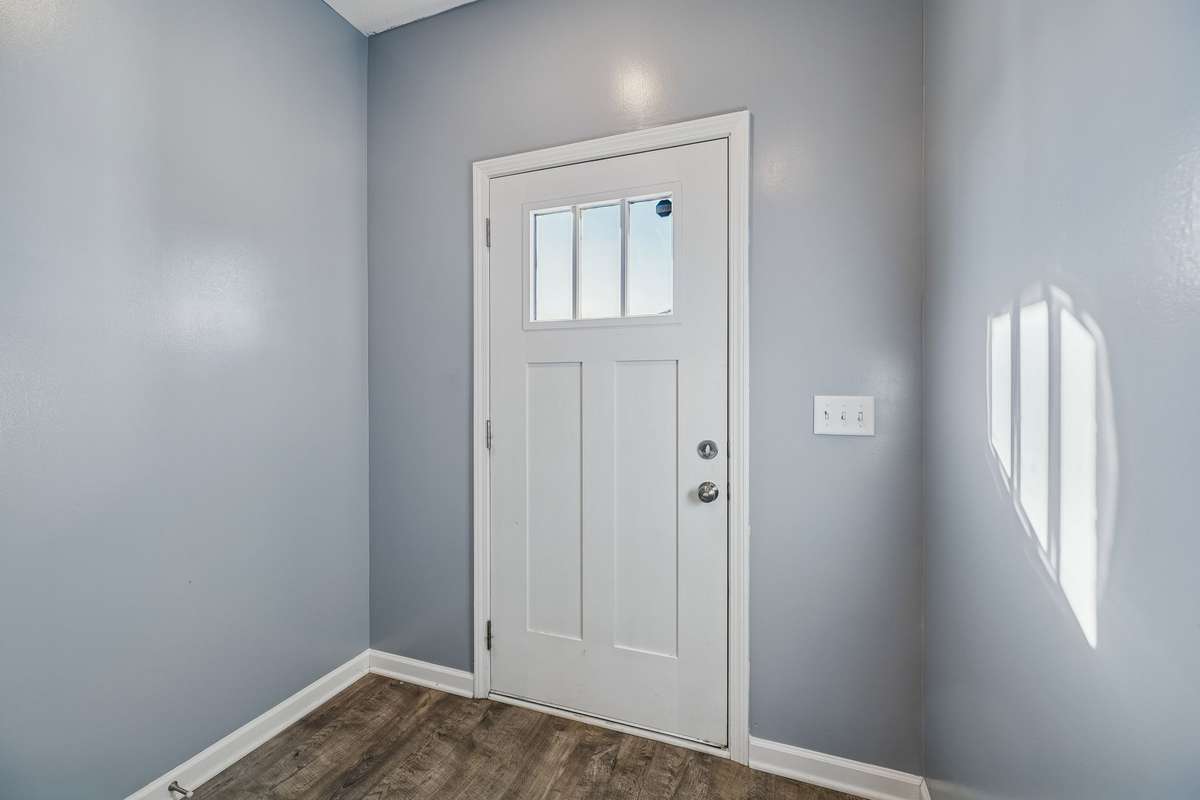 The light neutral paint found throughout the home compliments the warm laminate flooring.