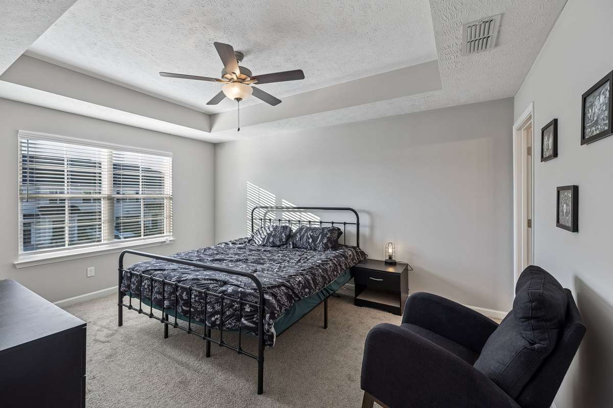 The primary bedroom has a large front window allowing more natural light into this space and coffered ceiling for adds a nice design touch.