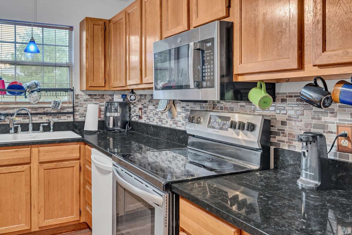 Granite countertops, stainless steel appliances, & a window view of the world!