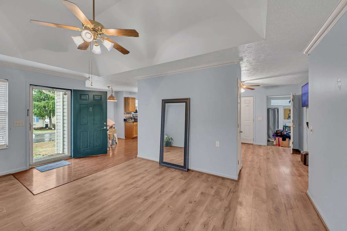 Look at this living room! Tray ceiling and beautiful hardwoods. Open floorplan allows you to see the cook and the dining area.