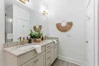 Primary bath features double vanities, new fixtures, freshly painted cabinets, hardware and lighting, plus a walk-in linen closet.