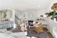 Living room with gas fireplace, lots of natural light.