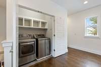 Laundry room conveniently located upstairs with primary suite and second bedroom.