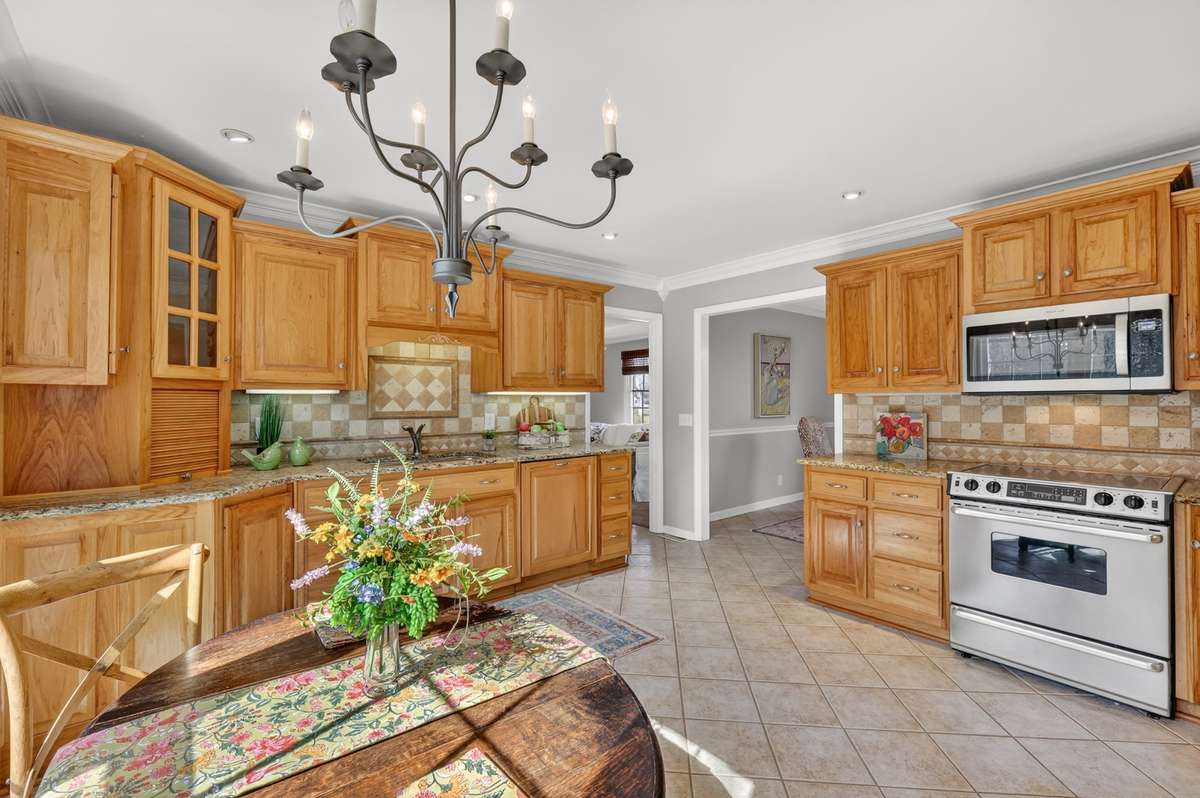 Lots of solid wood custom cabinetry and all stainless appliances (did you notice the wood paneled dishwasher?!!!) make for a great kitchen with a sunny breakfast area.
